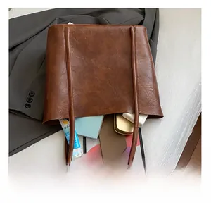 Spacious interior of dark brown leather tote bag showing capacity for tablets and daily items