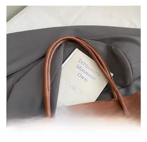 Close-up of comfortable leather handle and texture on a vintage brown bucket bag