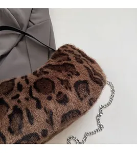 Close-up of leopard print faux fur texture and silver metal chain strap on handbag