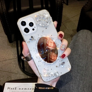 Close-up of luxury iPhone case featuring embedded mirror, crown crystal, and Love text