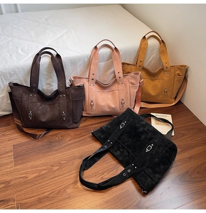 Detail of four colorful tote bags with metal studs and detachable shoulder straps
