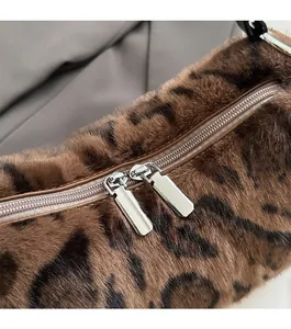 Macro shot of smooth leopard print faux fur texture with dual silver metal zippers