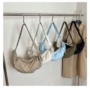Group shot of nylon dumpling bags in khaki, beige, blue, green and black colors