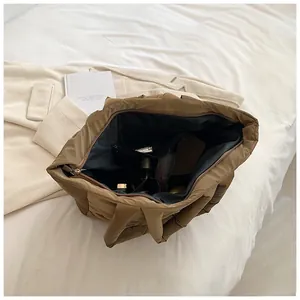 Interior view of quilted puffer tote bag with organizer pockets for cosmetics