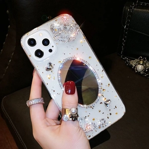 Detailed view of luxury iPhone case with embedded gold foil, makeup mirror and crown