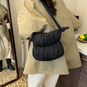 Chic black quilted puffer crossbody bag with knotted shoulder strap and cloud texture