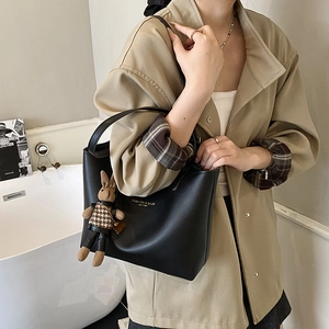 Large black leather tote bag with rabbit charm and gold fashion logo for women