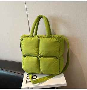 Detailed view of grass green quilted puffer tote bag with handles and shoulder strap