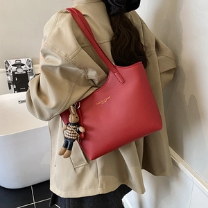 Red large-capacity lychee leather tote bag with stylish rabbit charm and golden text