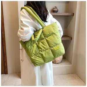 Macro shot of bright green quilted tote bag showing square stitching and fashion tag