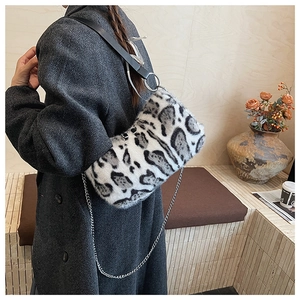 Detail of leopard print faux fur shoulder bag featuring silver chain and leather strap