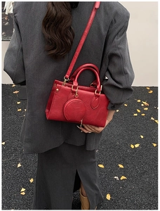 Red leather handbag with detachable shoulder strap and coin pouch accessory