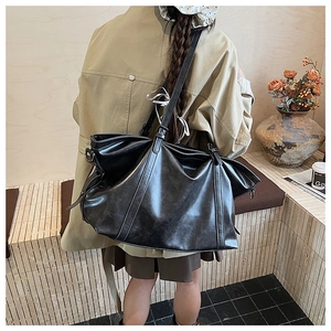 Model view of a large black vintage oil-wax leather tote bag for daily commute