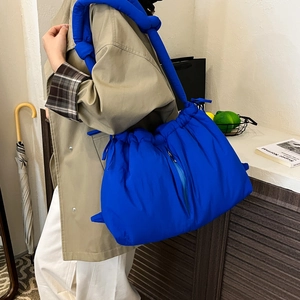 Klein blue padded bucket bag with knotted shoulder strap for daily casual commuting