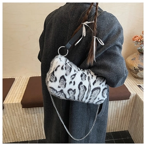 Detail of leopard print plush shoulder bag with silver ring and metal chain accessory