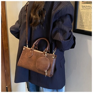 Brown leather square crossbody bag with mini round coin purse and gold hardware detail
