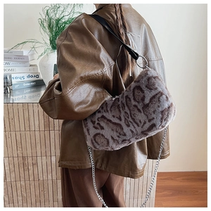 Detail of faux fur animal print bag with silver chain and leather shoulder strap