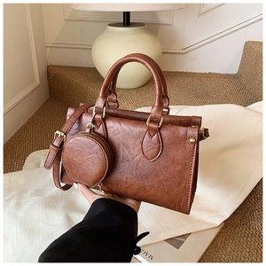 Detail of vintage brown square crossbody bag with a matching round coin purse attachment