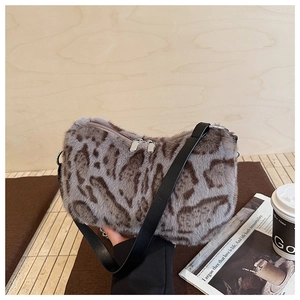 Close-up of plush leopard print shoulder bag with leather strap and silver zipper