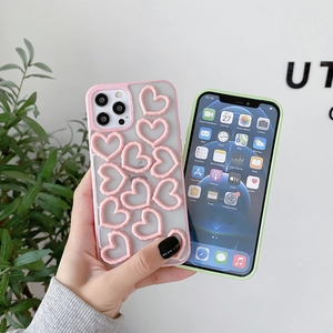 Detail of iPhone case featuring 3D pink hearts on frosted translucent back cover