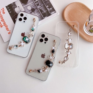 Dettaglio custodia iPhone trasparente con catena di gemme di lusso e strass lucidi