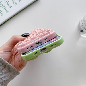 Detail of pink and green iPhone case showing precise bottom cutouts and 3D relief texture