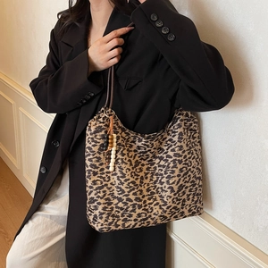 Vintage leopard print tote bag with beaded detail on a model in a black blazer