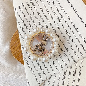 Macro view of a gold rabbit phone grip with pearl border and star details