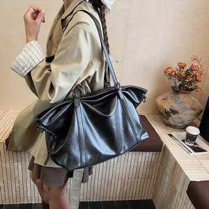 Classic black leather tote bag for women shown as a stylish crossbody shoulder bag