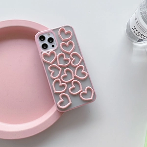 Pink iPhone case featuring 3D heart shapes and a frosted translucent back panel