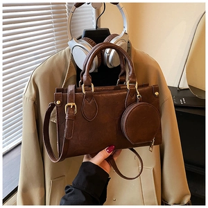 Detail of vintage brown crossbody bag with matte texture and mini round coin purse