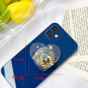 Detail showing heart phone grip with golden bow and pearls, size 52mm by 57mm