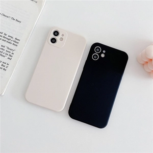 Lifestyle shot of black and off-white matte silicone phone cases with camera protection