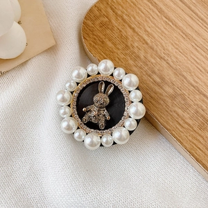 Macro detail of cell phone grip featuring golden vintage rabbit and pearl rhinestones