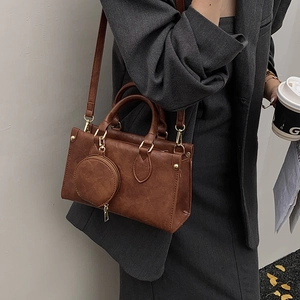 Vintage dark brown square crossbody bag with a round coin purse and gold hardware detail