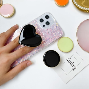 Collapsible heart shaped phone grip with gold trim in assorted vibrant colors