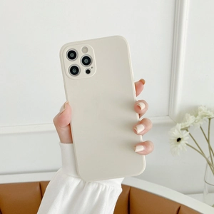 Detailed shot of cream silicone phone case with matte finish held in a hand