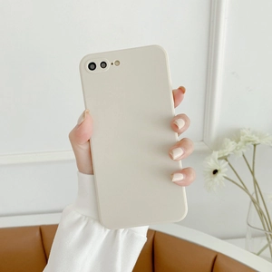 Close-up of minimalist creamy white silicone case on a phone with precise camera cutouts
