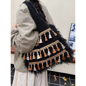 Bohemian black knitted tote bag with multi-color fringe tassels and feather trim details