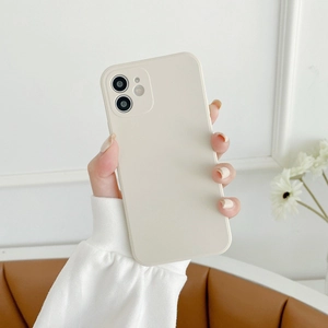 Close-up of cream silicone phone case with full camera protection held by a model