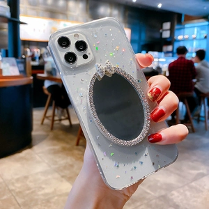 Detailed view of iPhone glitter case with rhinestone mirror and sparkling bow decor