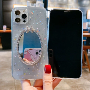 Detailed view of iPhone glitter case featuring stars, sequins, and a vanity mirror with bow