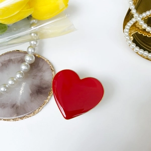 Detail view of red heart phone socket with gold trim on decorative marble display