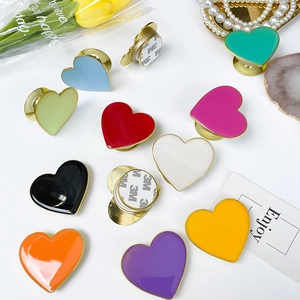 Detail of colorful heart-shaped phone grips with metallic edges and 3M adhesive backing