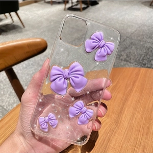 Sparkly clear phone case with purple resin bows and glitter for iPhone 16 Plus
