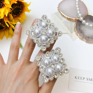 Detail of square phone socket grips with large white pearls and sparkling rhinestones