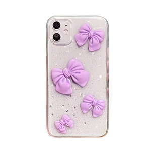 Glittery transparent iPhone case with purple 3D bows and silver sparkles for women