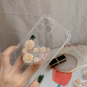Macro detail of a 3D resin rose and butterfly heart-shaped phone grip on a clear TPU case