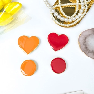 Detail of red and orange heart and round enamel foldable phone stand accessories