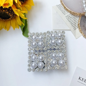 Detail of square phone socket with sparkling rhinestones and elegant pearls decoration